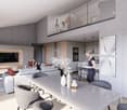 The image shows a modern, open-concept living room and kitchen area. The living room features a large gray sectional sofa, a coffee table, and a wall-mounted TV. The kitchen has sleek white cabinets, a gray countertop, and built-in appliances including a