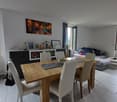 dining room, wooden table, 4 chairs, painting on wall, coffee table, sideboard, couch, window, radiator