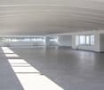 large room, empty, tile floor, curved ceiling, white walls, windows