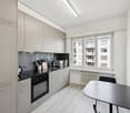 modern kitchen with appliances, wooden floors, central heating, view of the outside