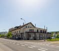 2 story house with a basement, glass windows, balconies, street lamp