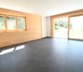 large windows, sliding glass doors, wood paneled walls, tiled flooring