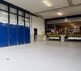 warehouse, large double doors, raised ground floor, white walls, large windows, white floor, storage boxes