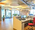 office room, wooden floor, two monitors, keyboard, mouse, desk, chair, plants, round ceiling lights