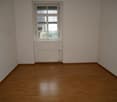 empty room, wooden floor, white walls, window, radiator