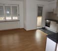 Wooden floors, open kitchen, sliding glass door, white radiator, large windows, glass windows