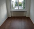 empty room, large window, wooden floor, white radiator