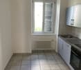 Kitchen with tiled floor, white wall, double windows, radiator, kitchen sink, oven