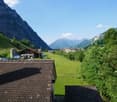 view of mountains, houses, and a green valley