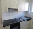 modern kitchen with white cabinets, black countertops, stainless steel sink, electric stove, oven, dishwasher, washing machine