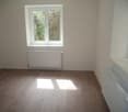 empty room, wooden floor, white walls, two windows, two radiators