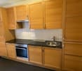 kitchen with oven, hob, sink, tiles, cabinets, counter top