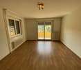 empty room, wooden floor, sliding glass door, balcony, radiators, ceiling lamp