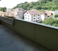 concrete balcony, metal railing, planter, view of the town