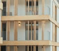 modern multistory building, wooden and white finish, multiple balconies