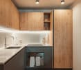 Modern kitchen with wooden cabinets, white countertops, and a sleek black stove.