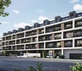 Multi-story apartment building with balconies, modern architectural design, and greenery surrounding the building.