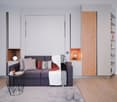 Modern living room with gray sofa, wooden shelving units, and a built-in fireplace. The room has a minimalist and cozy design with neutral colors and natural wood accents.