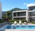 3 story white building, swimming pool, large windows, white lounge chairs, green bushes, mountains in the background
