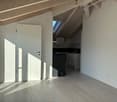 Empty room with wooden floor, white walls, glass door, glass wall, kitchen and window