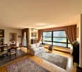 living room, white couch, window, table, lamp, rug, dining chairs, wooden floor