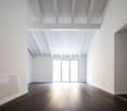 Empty room with white walls, wooden floor, white ceiling, sliding glass door, power outlets