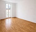 Empty room with wooden floor, white walls, ceiling light, large window