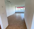 empty room, wooden parquet floor, white walls, balcony with glass doors, ceiling lights, power outlets