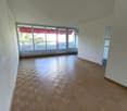 empty room, wooden parquet floor, large windows, balcony