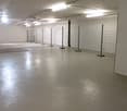 Empty room, white walls, white floor, metal fences, lights on the ceiling