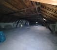 empty attic room, wooden beams, concrete floor, no windows