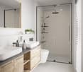 Modern bathroom with white walls, wood vanity, vessel sink, large glass shower enclosure, and recessed lighting.