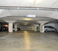 Underground parking garage with multiple parking stalls and private parking sign