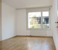 empty room, wooden floor, white walls, large window, radiator