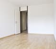 empty room, white walls, wooden floor, open door, hallway