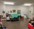 Chaise lounge, desk, storage boxes, artworks, radiator, floor lamp, shelves
