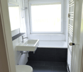 Bathroom with toilet, sink, bathtub, and shower