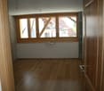 empty room, wooden floor, large window, white walls
