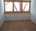 empty room, wooden floor, white walls, large window, power outlets