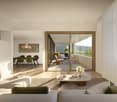 modern living room with large windows, sliding glass doors to balcony, wooden floor, white walls, large sofa, coffee table, decorative plant, books, and a view of a garden and landscape