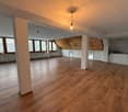 empty room, wooden floor, white walls, large windows, wooden ceiling, kitchen area