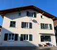 2 story house, white walls, green shutters, satellite dish, entrance with steps