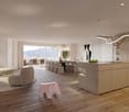 large living room with wooden floors, a kitchen, dining table, and chairs, a couch, a round coffee table with flowers, a desk, and a large window with a terrace
