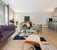 modern interior, large windows, glass table, zebra chairs, modern sofa, kitchen island