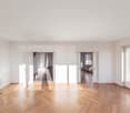 Empty room, large windows, sliding doors, wooden floors, open doorways, balcony