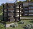 Modern apartment building with multiple balconies, glass windows, and a landscaped garden