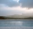 Marble floor, Infinity pool, mountain range, horizon, greenery, foggy weather