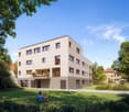 4 story house, white exterior, brown ground floor, balcony, bicycles parked outside