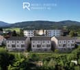 3 row buildings, modern architecture, multiple floors, surrounded by greenery and mountains, balcony at each floor