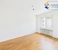 empty room, white walls, wooden floor, white radiator, window
